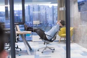 young businessman relaxing at the desk photo