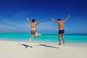 happy young  couple enjoying summer on beach photo