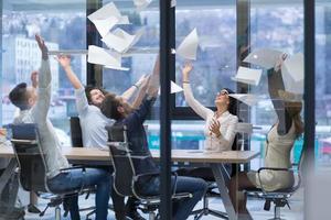 startup Group of young business people throwing documents photo