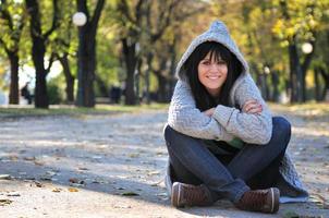 Cute young woman smiling outdoors in nature photo