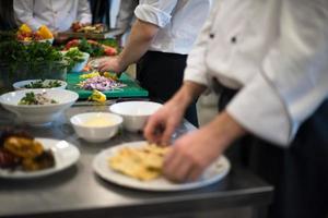 team cooks and chefs preparing meal photo