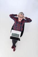 top view of young business woman working on laptop computer photo