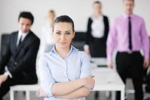 business woman standing with her staff in background photo