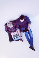 top view of  couple working on laptop computer at startup office photo