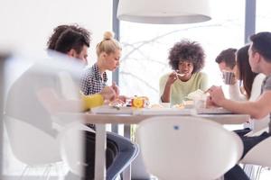 multiethnic group of happy friends lunch time photo