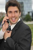 Photo of happy winner businessman  talking on mobile phone