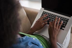 African American women at home in the chair using a laptop photo