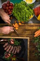top view of Chef hands serving beef steak photo