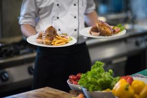 Chef showing dishes of tasty meals photo