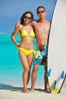 happy young  couple enjoying summer on beach photo