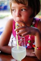 Cute little gilr enjoying cold drink photo