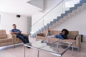 young multiethnic couple relaxes in the living room photo