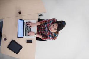 top view of young business woman working on laptop photo