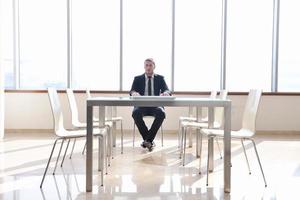 business man alone in conference room photo