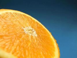sliced orange macro with blue background photo