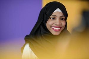 muslim woman with a beautiful smile wearing a hijab poses in the studio photo