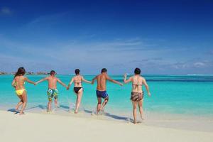 group of happy young people have fun on bach photo