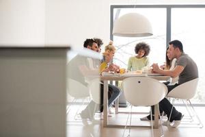 multiethnic group of happy friends lunch time photo