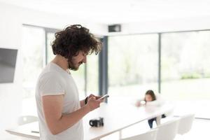 young man using a mobile phone  at home photo