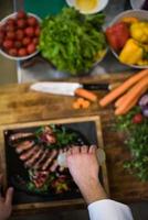 top view of Chef finishing steak meat plate photo