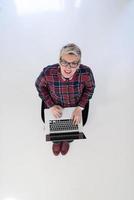 top view of young business woman working on laptop computer photo