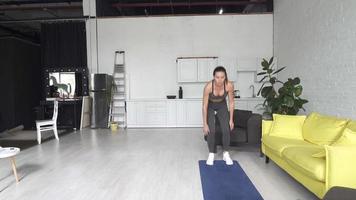 Young woman doing a home work out session video