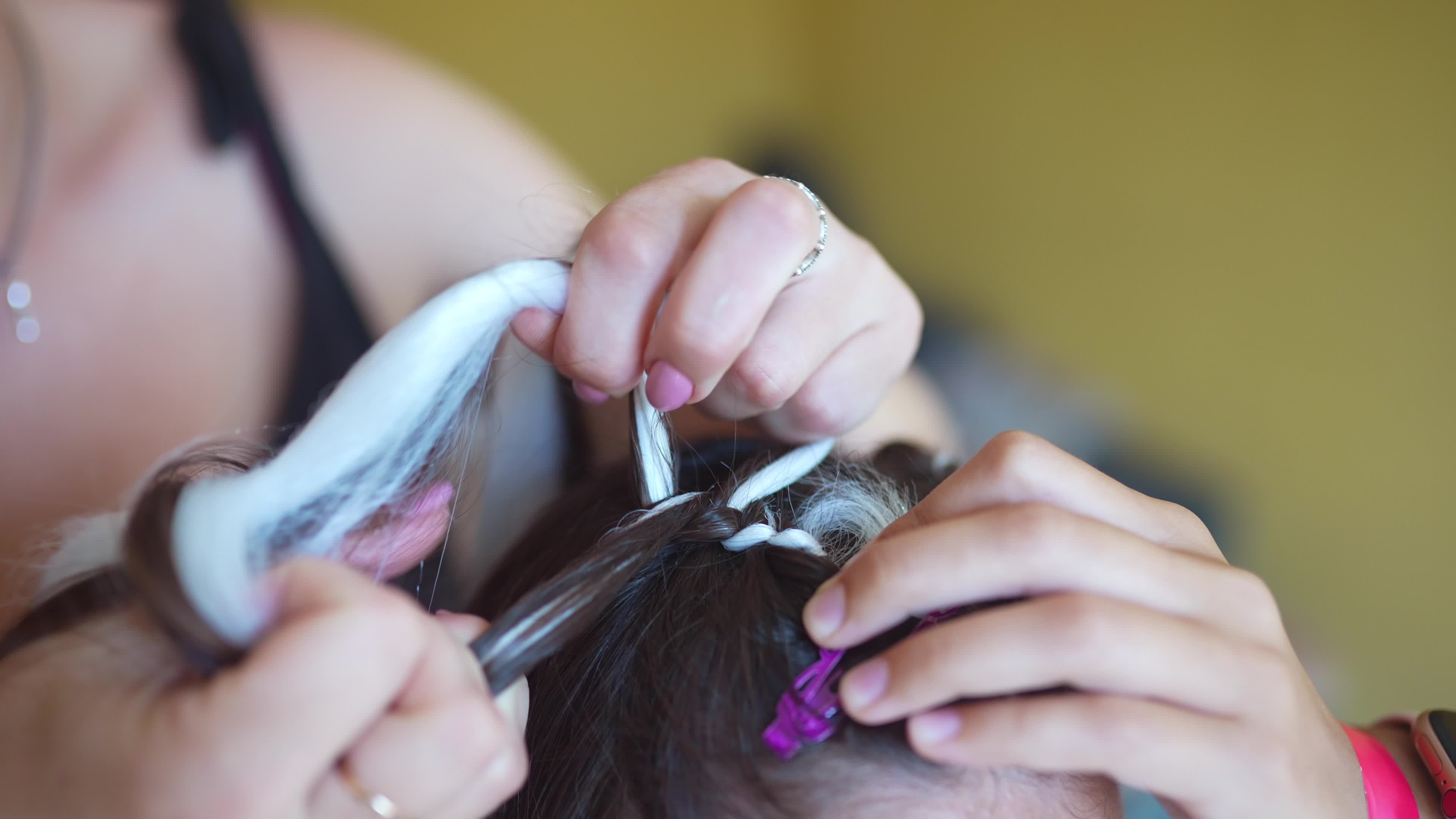 Girls braiding hair with a white strand of hair 12127315 Stock Video at