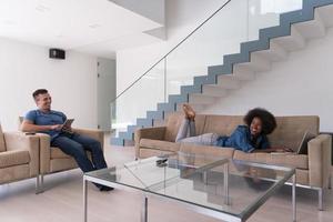 young multiethnic couple relaxes in the living room photo