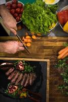 top view of Chef hands serving beef steak photo
