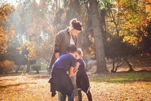 Mother with kids spending a day in the park. photo