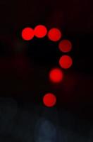 Question mark make with red light in abstract background. photo