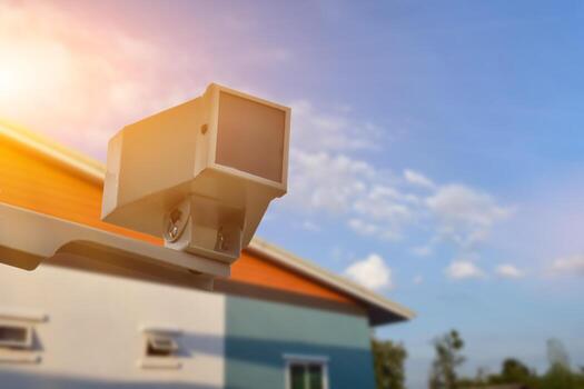 mini ip cctv camera installed on wooden pole to do the security instead of human by monitoring through mobile phone, soft and selective focus. photo