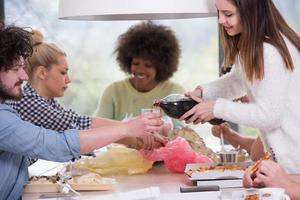 multiethnic group of happy friends lunch time photo