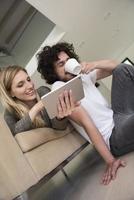 couple relaxing at  home with tablet computers photo