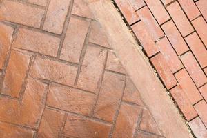 Red brick wall background in rural room. Abstract weathered texture stained old stucco light Red. Red grunge brick wall background. photo