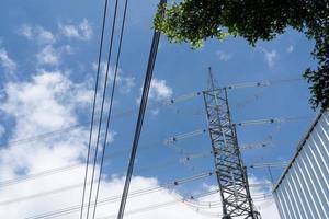 torre de transmisión de electricidad contra el cielo azul. poste de electricidad de alto voltaje. foto