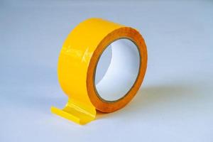 yellow duct tape roll on isolated background photo
