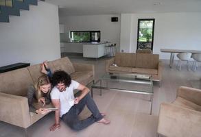 couple relaxing at  home with tablet computers photo