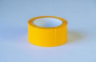 Rollo de cinta adhesiva amarilla sobre fondo aislado foto