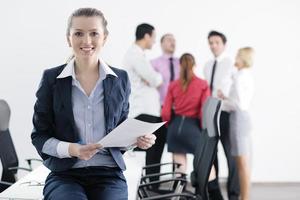 business woman standing with her staff in background photo