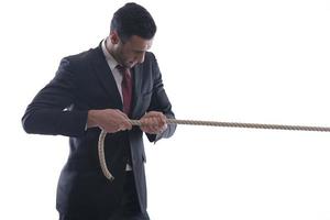 business man with rope isolated on white background photo