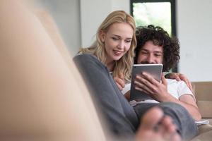 couple relaxing at  home with tablet computers photo