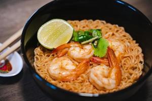 Spicy instant thai style noodles soup with shrimp - tom yum kung photo