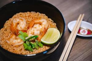 Spicy instant thai style noodles soup with shrimp - tom yum kung photo