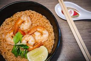 Spicy instant thai style noodles soup with shrimp - tom yum kung photo