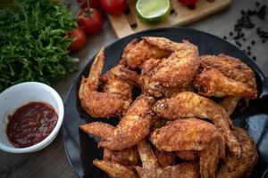 Hot Meat Dishes - Fried Chicken Wings on plate with salad photo