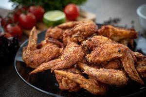 Hot Meat Dishes - Fried Chicken Wings on plate with salad photo