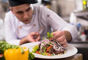 cook chef decorating garnishing prepared meal photo