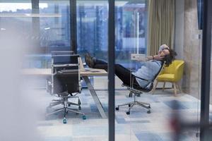 young businessman relaxing at the desk photo