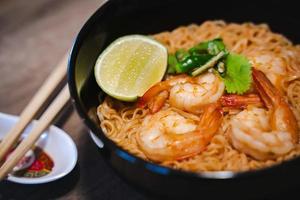 Spicy instant thai style noodles soup with shrimp - tom yum kung photo